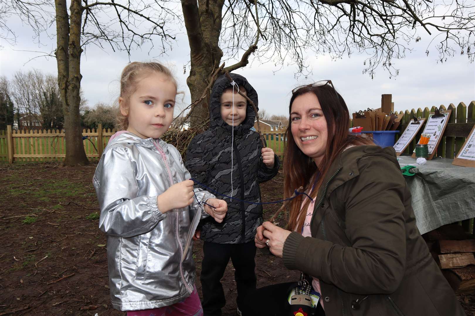 Felicity and Daniel get tips from Maria Lougheed during forest school at Sunny Bank Primary School