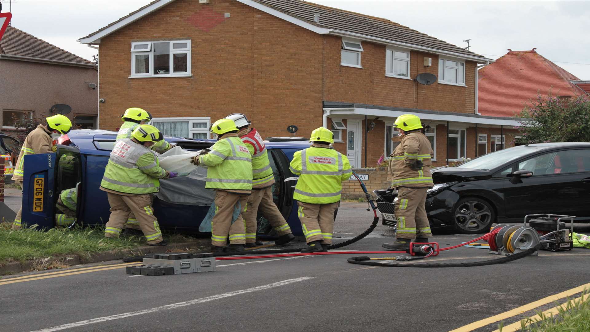 Firefighters removing the roof off one of the cars involved. Pictures: Geoff Gambrill