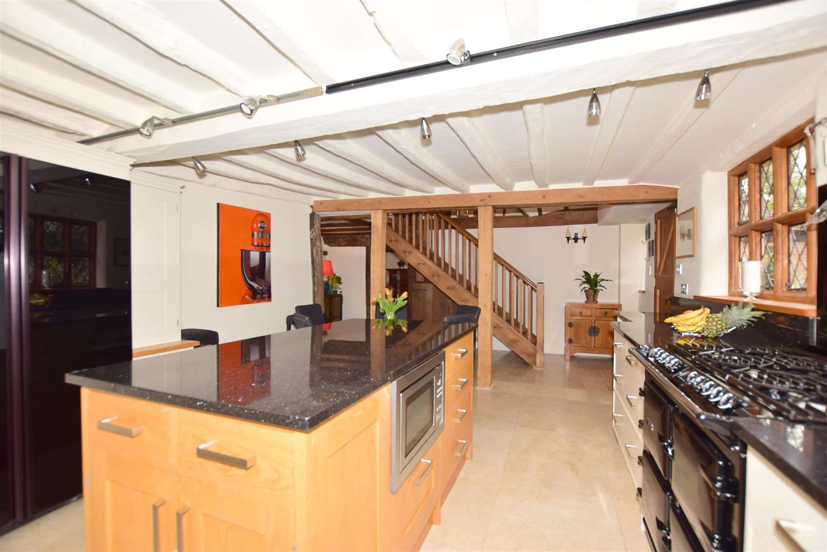 The kitchen has an island and there's a separate utility room