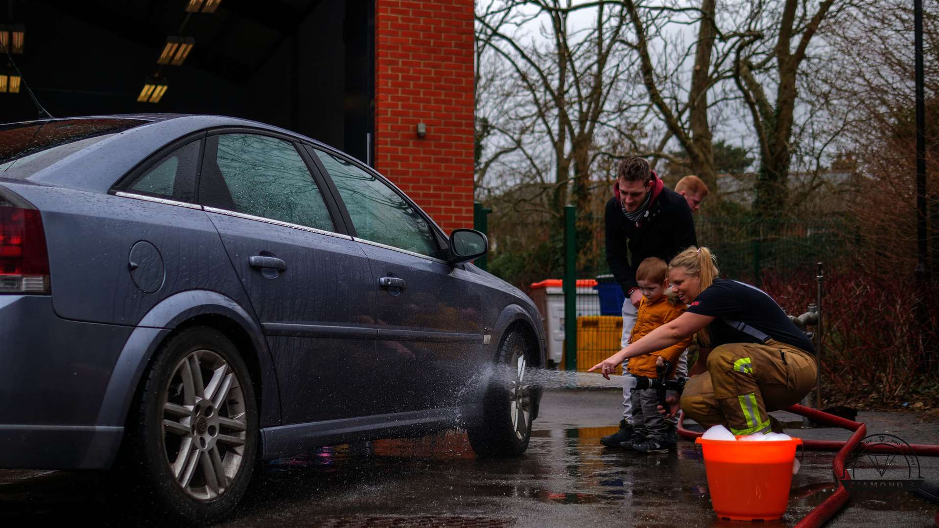 Firefighters washing cars for charity at Ash-cum-Ridley fire station in Chapel Wood Road, Ash. Picture: Diamond 9 Productions