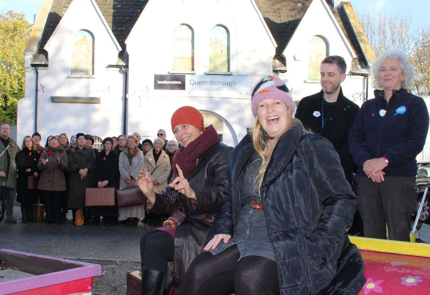 Tania Holland-Williams, left, and Emily Peasgood with Kevin Grist and Lucy Medhurst and the 55-plus choir at Queenborough railway station performing Never Again. Picture: John Nurden