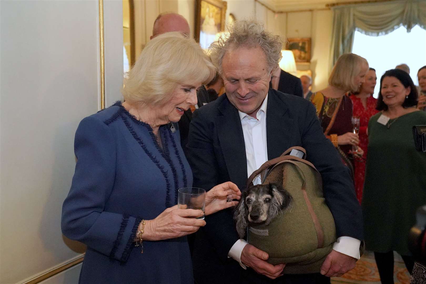 The Queen Consort meets author Charlie Mackesy and his dog Barney (Jonathan Brady/PA)