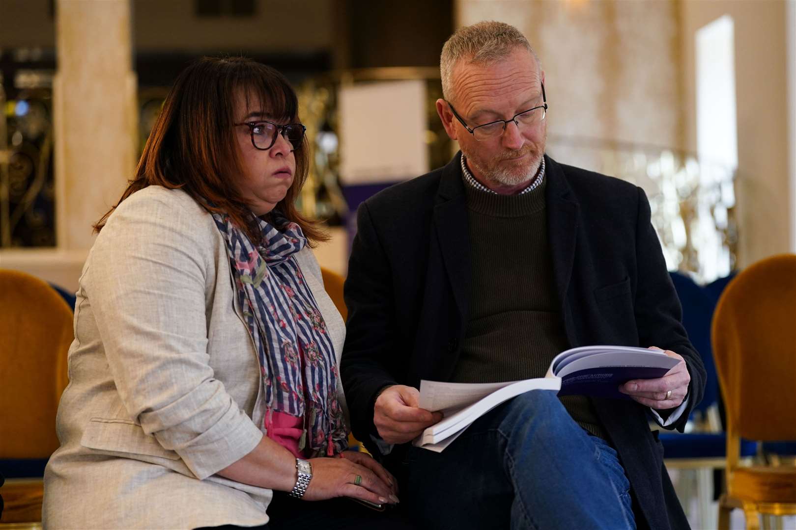 Julie and Neil Rowlings read the Ockenden report (Jacob King/PA)