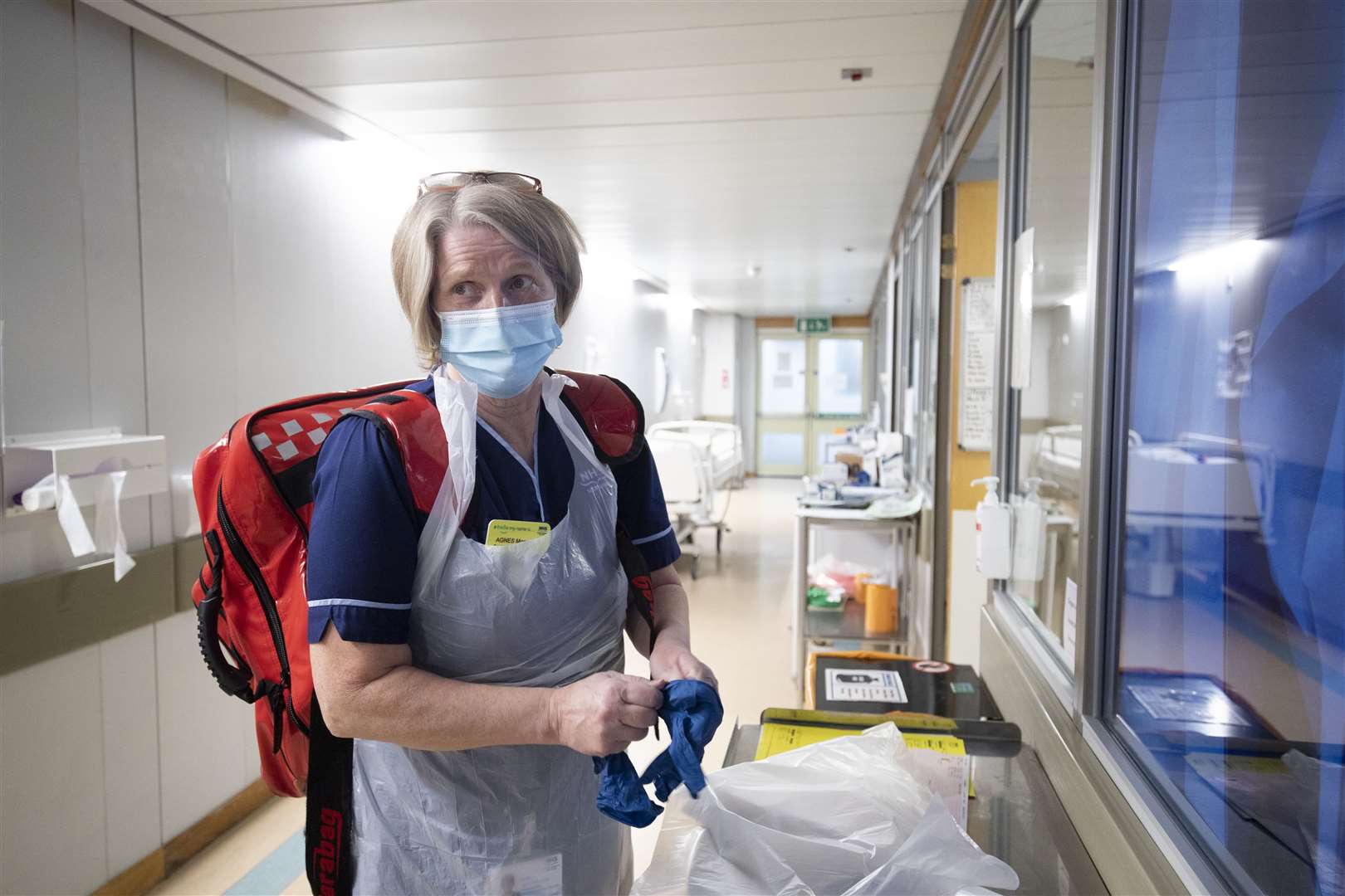 Senior charge nurse Agnes Monaghan prepares to transfer a patient from the specialist assessment treatment area (Jane Barlow/PA)