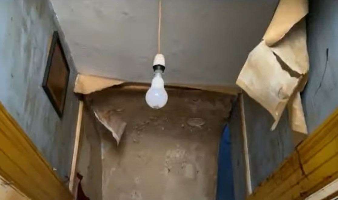 Wallpaper peeling from the hallway ceiling and walls. Picture: Clive Emson / YouTube