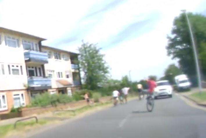 A boy narrowly misses a car as he cycles into oncoming traffic (5019765)