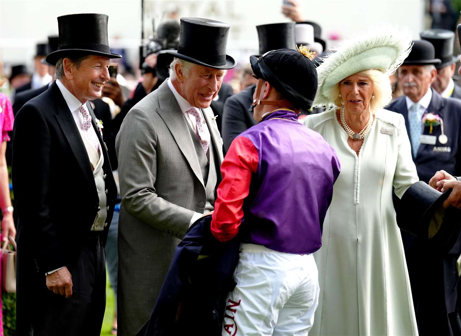 The King and Queen shake hands with jockey Tom Marquand who rode their first Royal Ascot winner. John Walton/PA