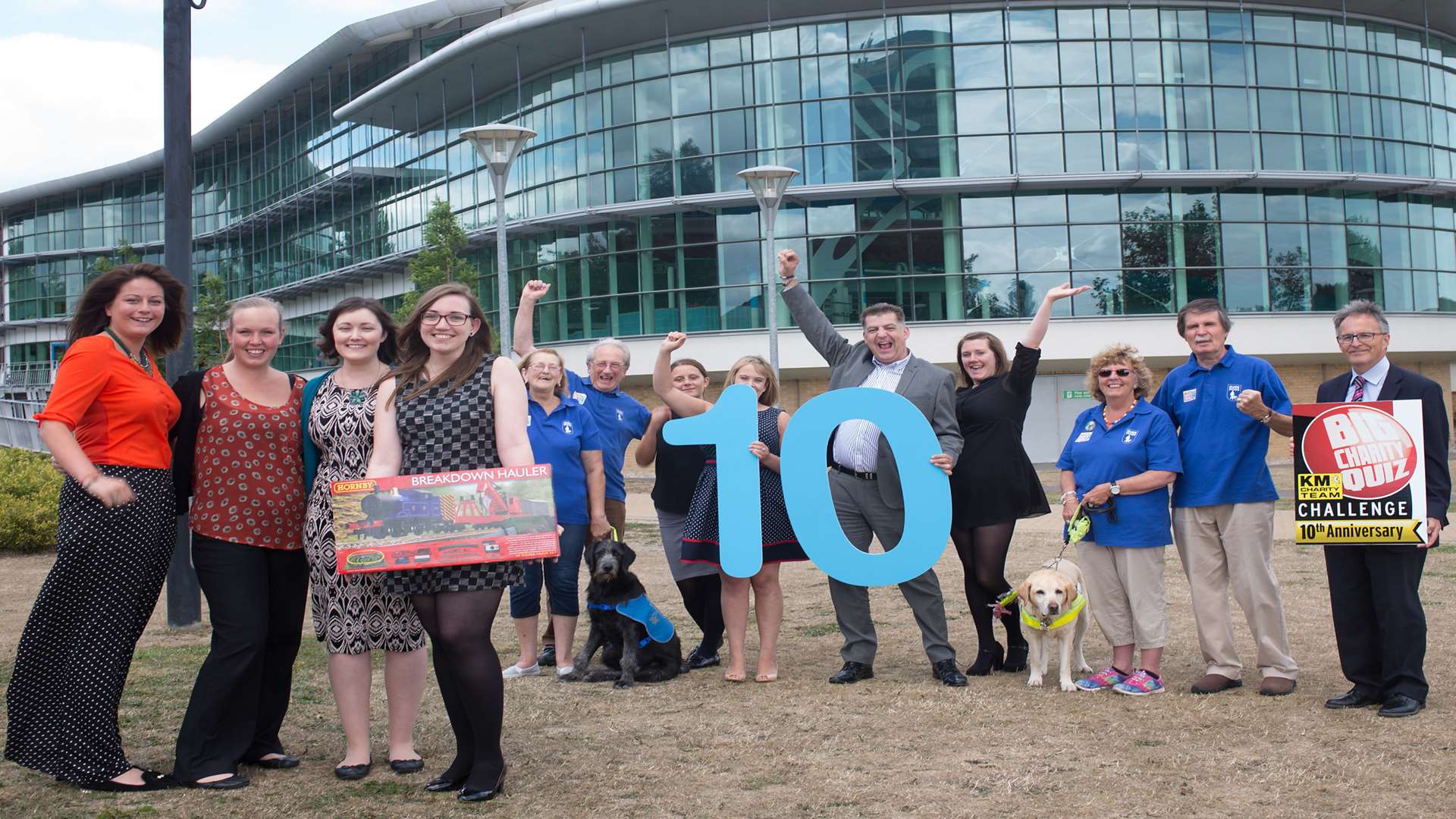 (front) Ellie Wood, Sophie Hillier, Rebecca Jones and Emma Jones of Hallett and Co plus a raffle prize from Hornby are joined by other partners of the 10th anniversary KM Big Quiz HR GO, Specsavers and Guide Dogs for the Blind.