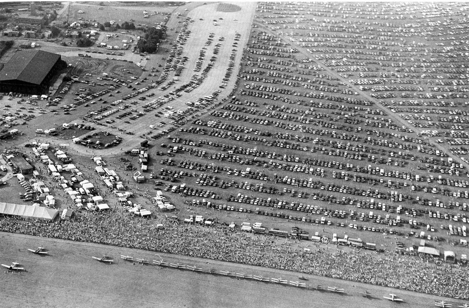 Great Warbirds air display, West Malling Airfield, Kent. An amazing aerial view of West Malling airfield, packed with spectators and their cars. August, 1990