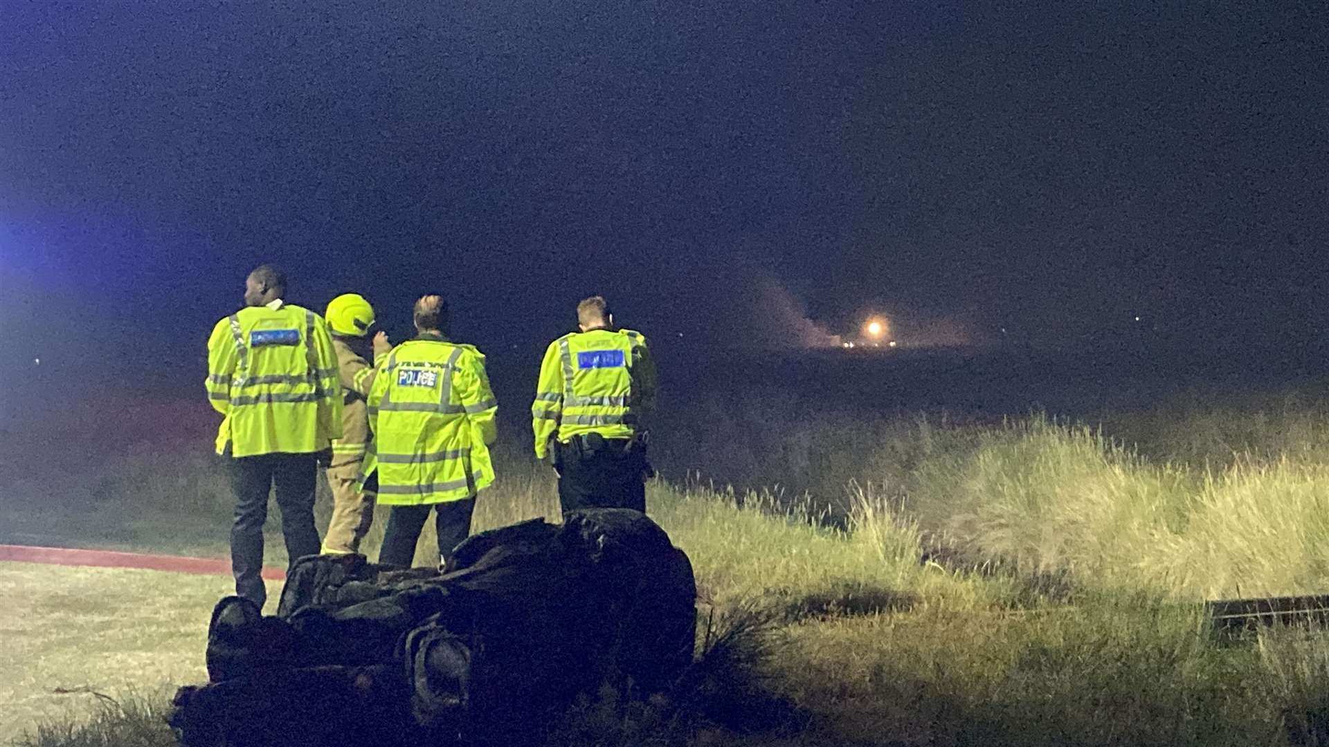 Police joined firefighters tackling burning grass following a model aeroplane display at Barton's Point Coastal Park, Sheerness. Picture: John Nurden
