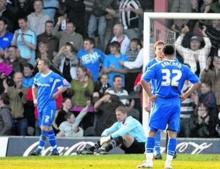 Gillingham keeper Simon Royce (seated) cuts a dejected figure as Grimsby go 2-0 up. Picture: Matthew Walker