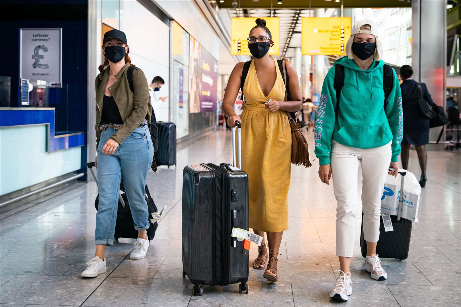 Alex Parr, left, Carmen Jones, centre, and Neringa Juskauskaite, who arrived at London Heathrow Airport from Pula, Croatia (Aaron Chown/PA)