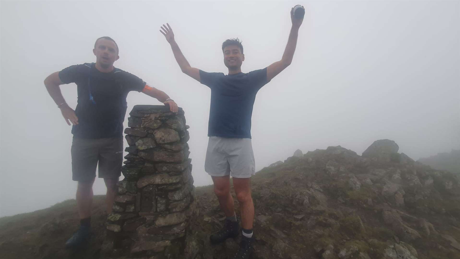 Jack Stacy and Michael Smith celebrate reaching the top of Scafell Pike, England’s highest peak during their 24 peaks in 24 hours challenge (SeeAbility)