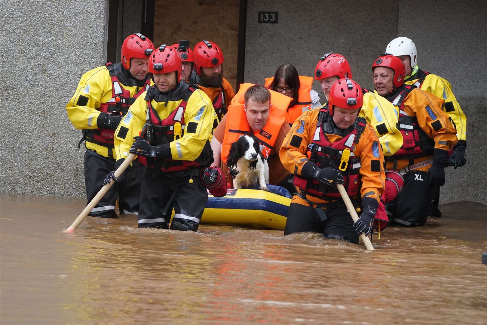 Members of the emergency services help local residents to safety in Brechin (Andrew Milligan/PA)