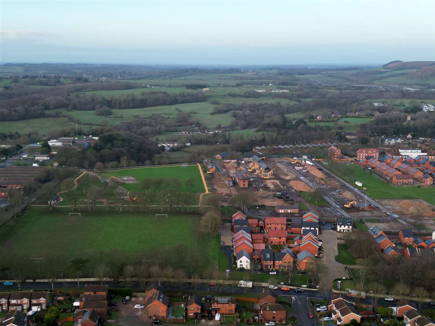 This drone image shows the ongoing demolition of Risborough Barracks, as well as some of the new homes already built on The Stadium plot of Shorncliffe Heights in Cheriton, Folkestone. Picture: Barry Goodwin