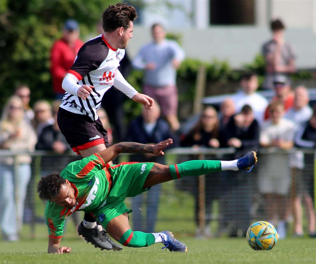 Lydd's Troy Howard battles for the ball in midfield with Deal's Ashley Miller. Picture: Paul Willmott