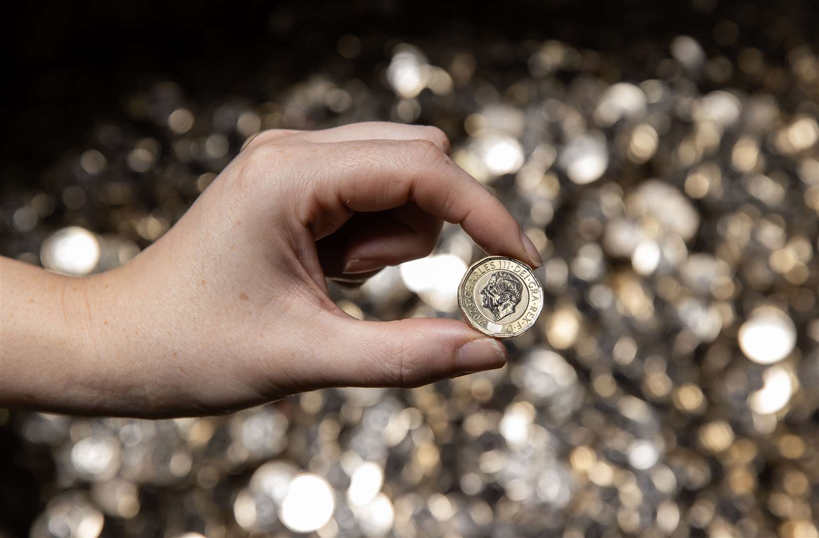 The new pressing of the £1 coin bearing the King’s official portrait (Chris Fairweather/Royal Mint/PA)