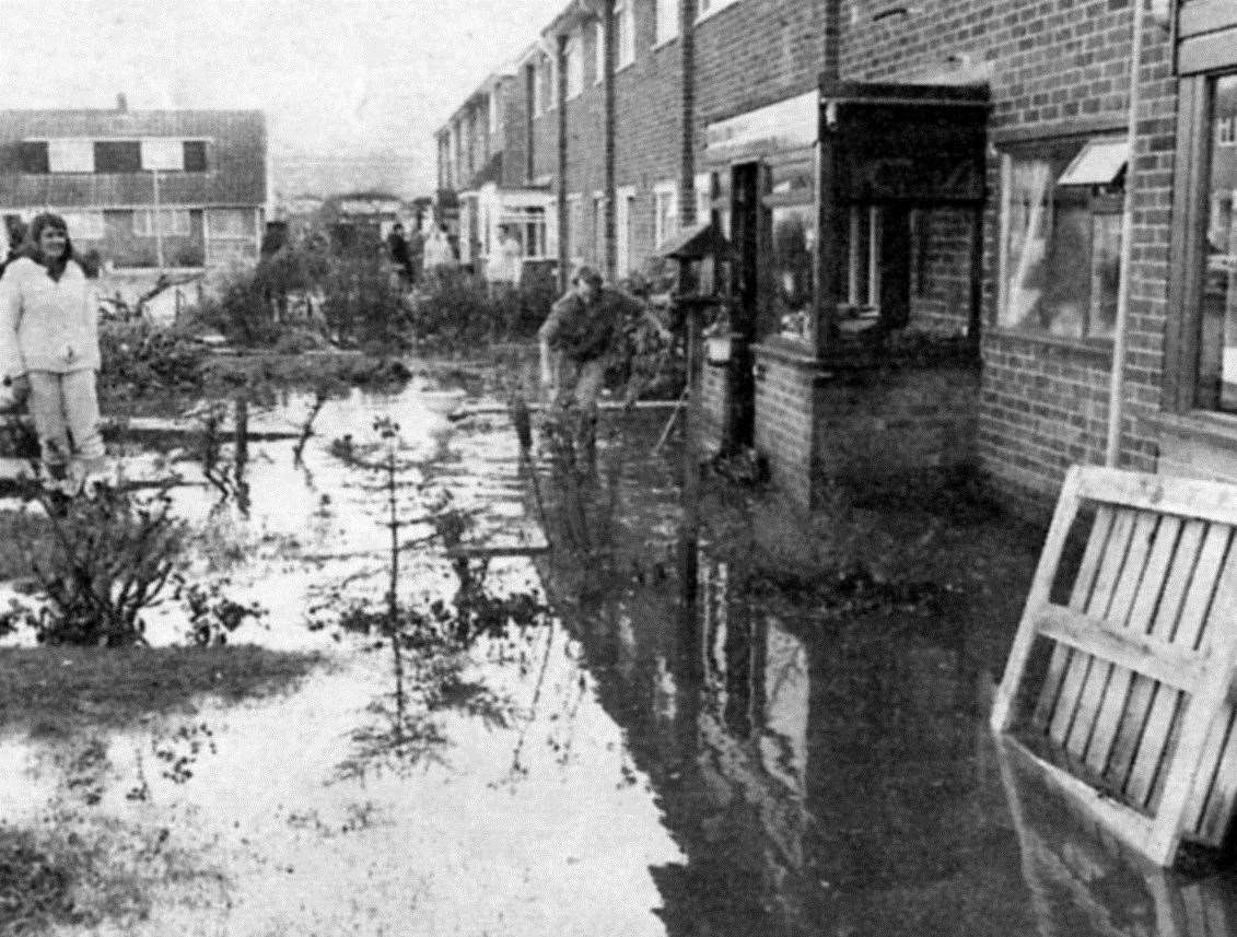 Flood water and debris outside homes