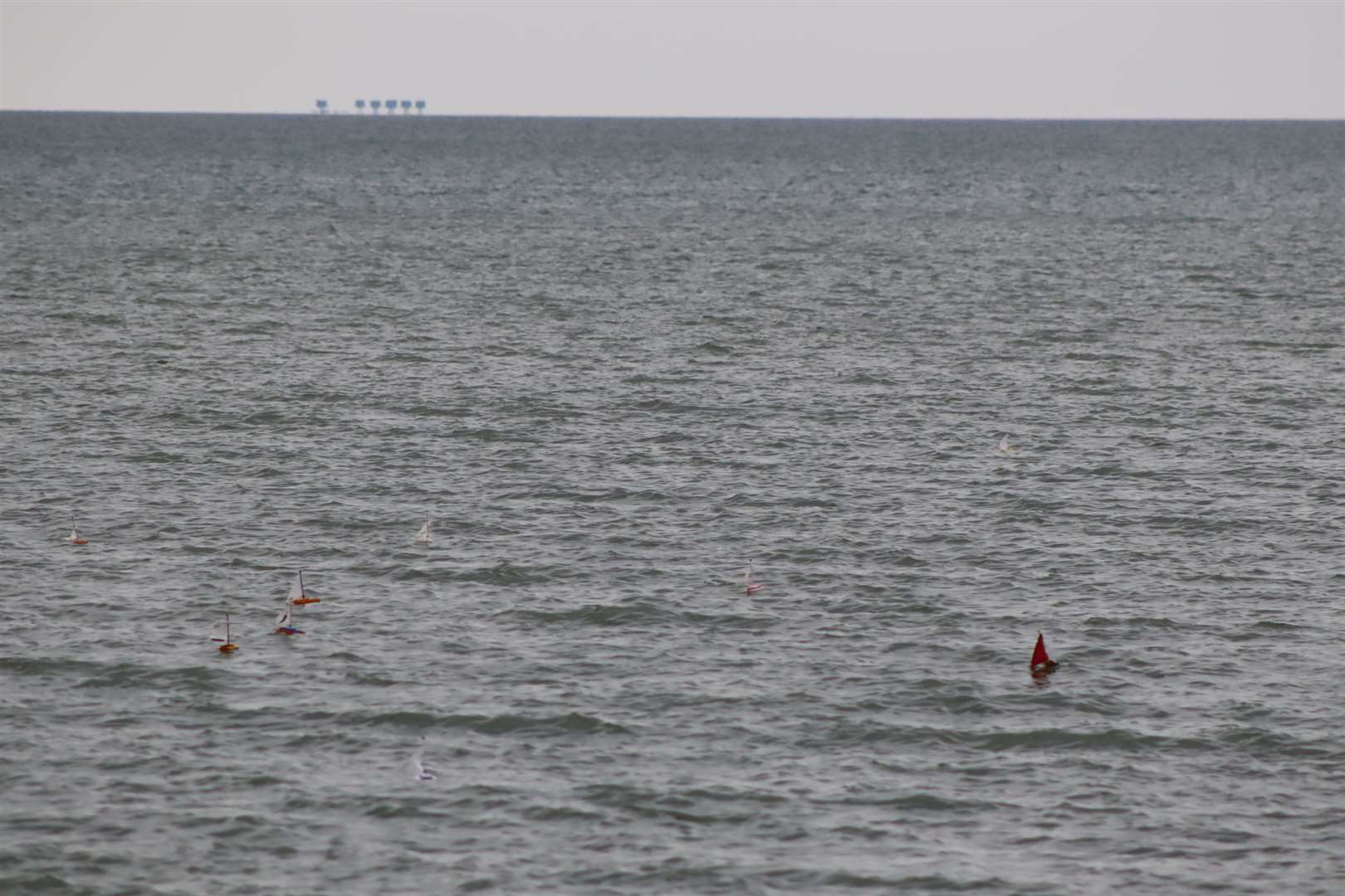 The boats on their way with the Second World War Maunsell sea forts in the background at Minster, Sheppey for the launch of the Freemasons' Great East Kent Boat Race