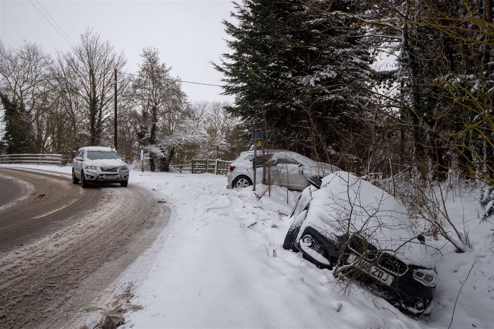 Abandoned cars in a snow-filled ditch in Needham Market, Suffolk (Joe Giddens/PA)