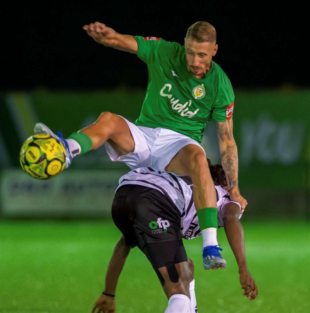 Ashford's Lee Martin goes for a ride on the back of a Margate player. Picture: Ian Scammell