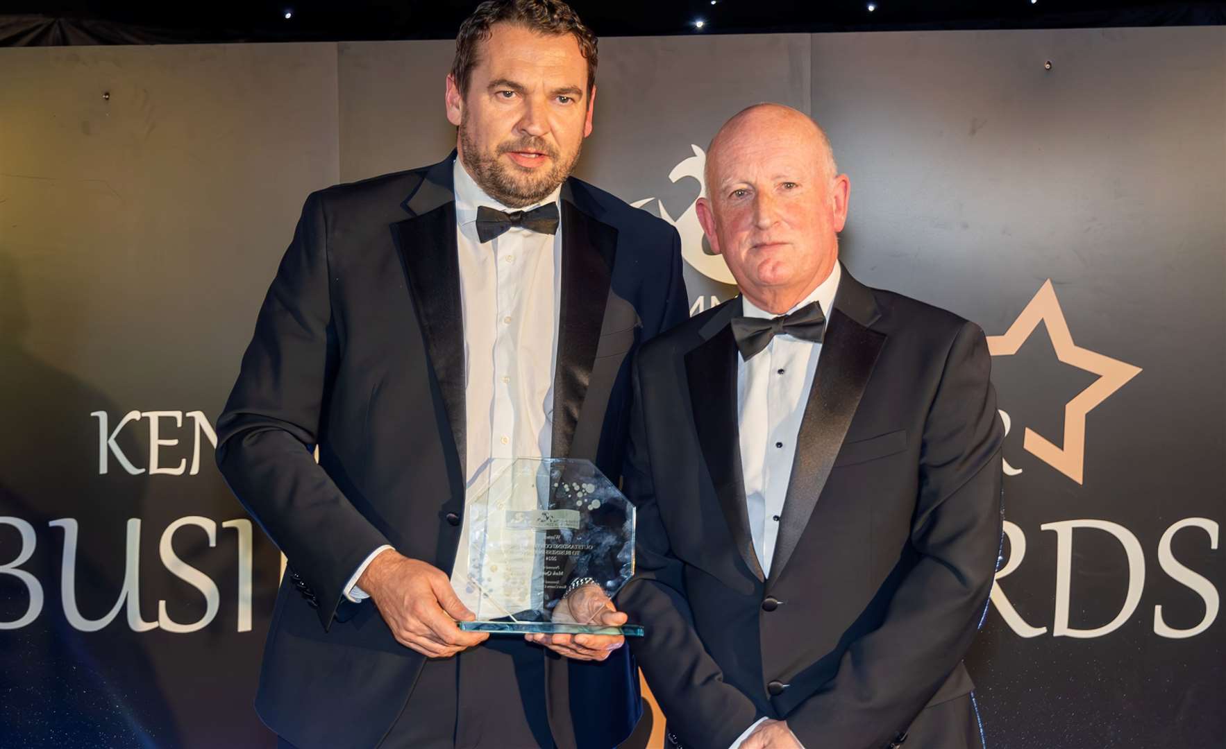 Mike Quinn, left, accepts his award from Cllr Derek Murphy of KCC