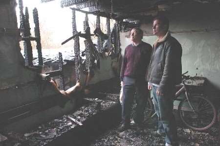 Club captain John Harvey and president Warwick Buckley amid the devastation. Picture: MATT WALKER