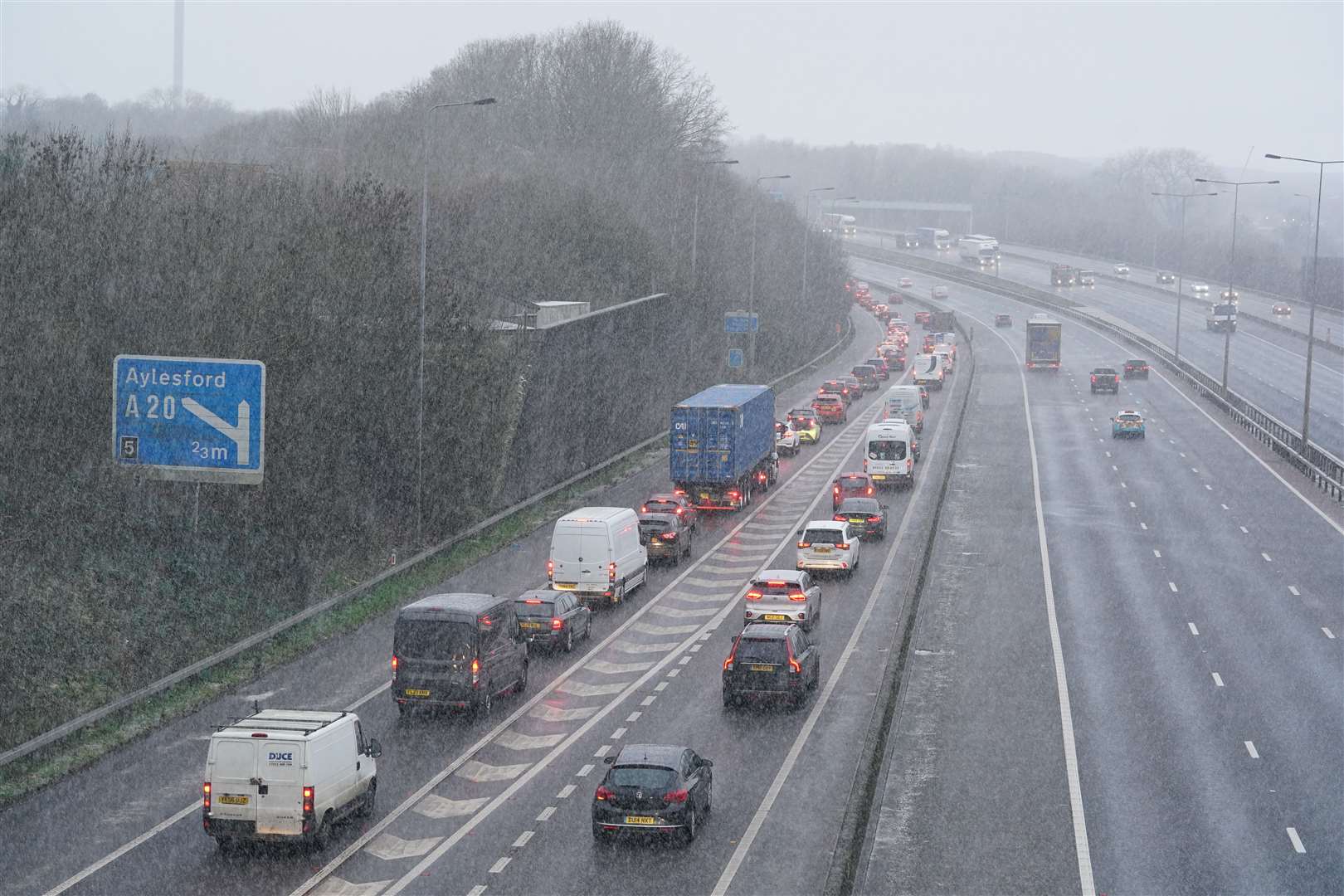 Vehicles drive through a snow shower on the M20 in Kent (Gareth Fuller/PA)