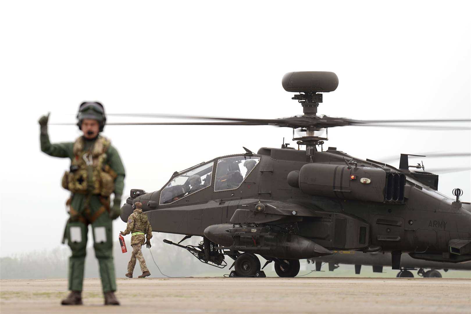 British Army Apache AH-64E attack helicopters are prepared for take off from Wattisham Flying Station in Suffolk (Joe Giddens/PA)