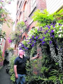 Cellist Robert Truman outside his flower-decked Cranbrook home. Picture: Trisha Fermor