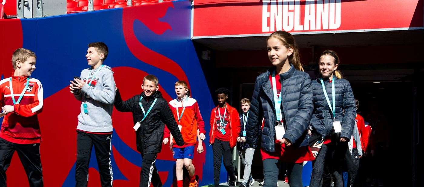 During the Wembley Stadium tour, visitors can walk out of the tunnel and stand pitch-side