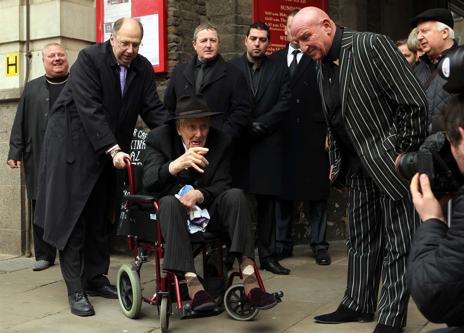 Ronnie Biggs talks to Dave Courtney (right) at the funeral of Bruce Reynolds, the mastermind behind the Great Train Robbery, at St Bartholomew The Great Church in Smithfield, London, in 2013 (Sean Dempsey/PA)