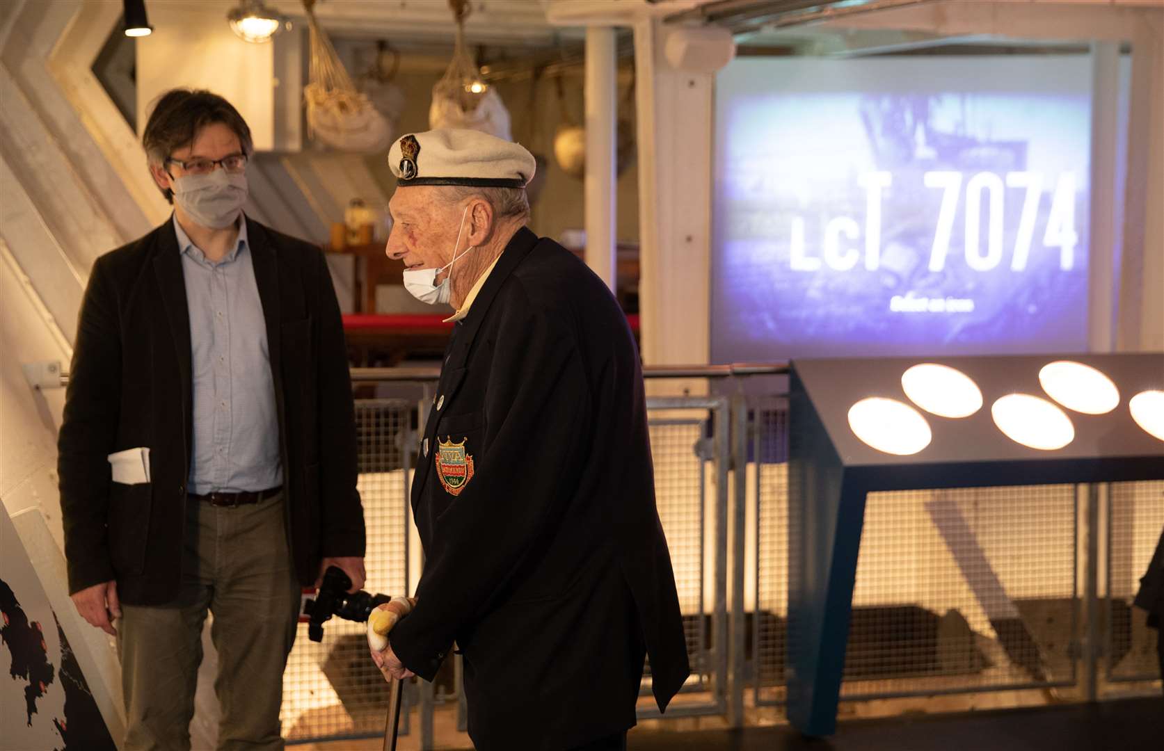 Veteran Bill Silvester (right), who was a member of Royal Navy communications team that went ashore on D-Day, is shown around the restored craft (Andrew Matthews/PA)