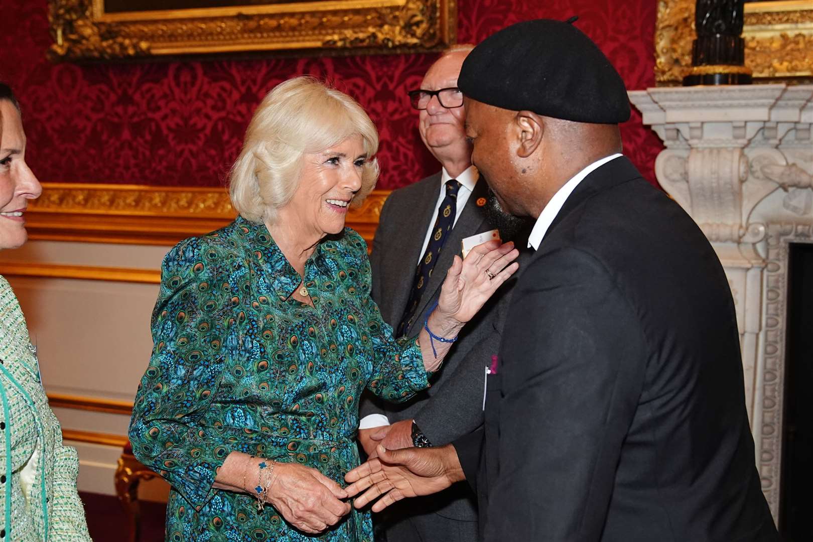 Camilla greeted key supporters of the charity, including poet and novelist Sir Ben Okri (right) during a reception to celebrate its 70th anniversary (Aaron Chown/PA)