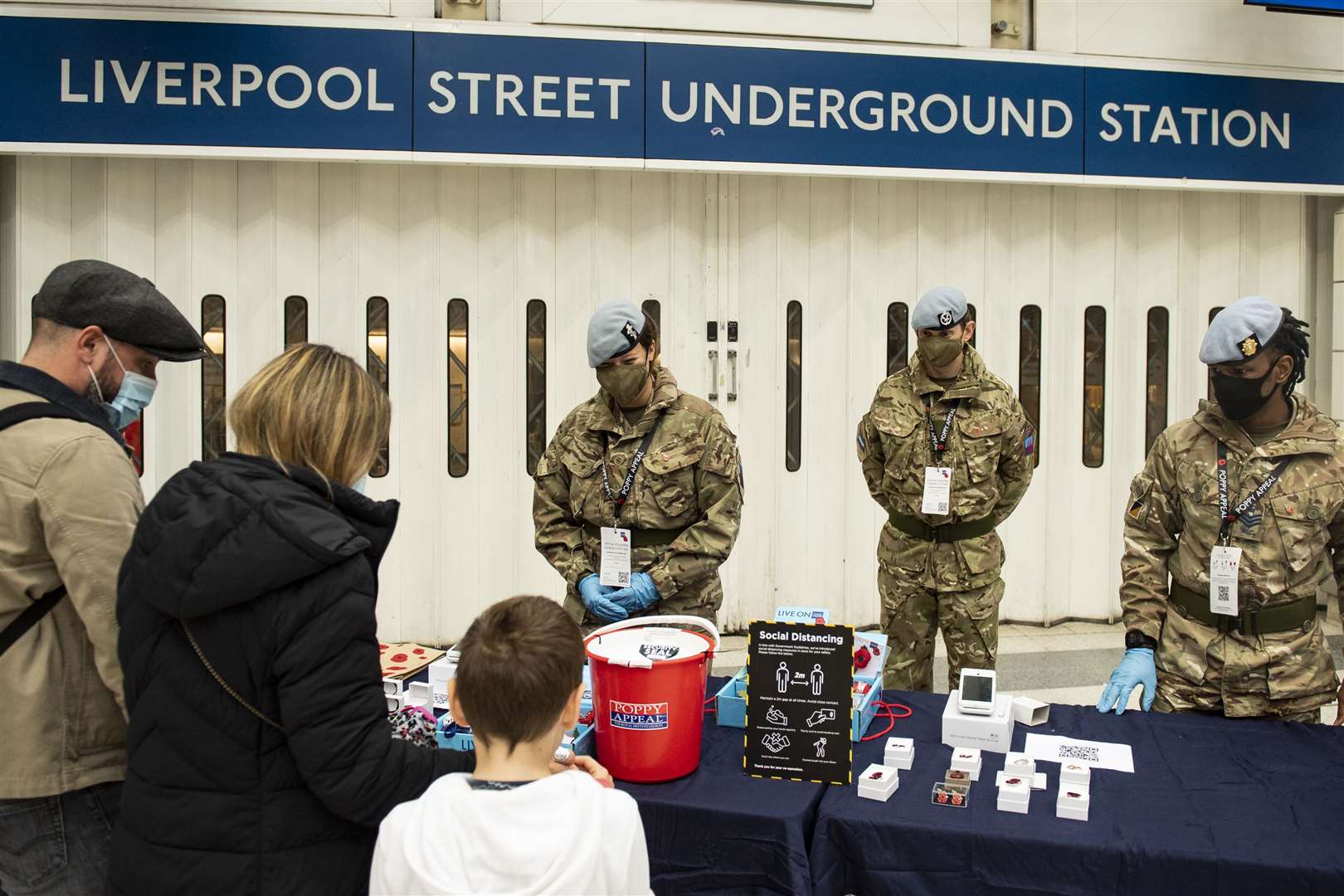 Members of 7 Battalion REME, 132 Aviation Support Squadron selling poppies at Liverpool Street underground station during London Poppy Day (Sergeant Todd/MoD/PA)