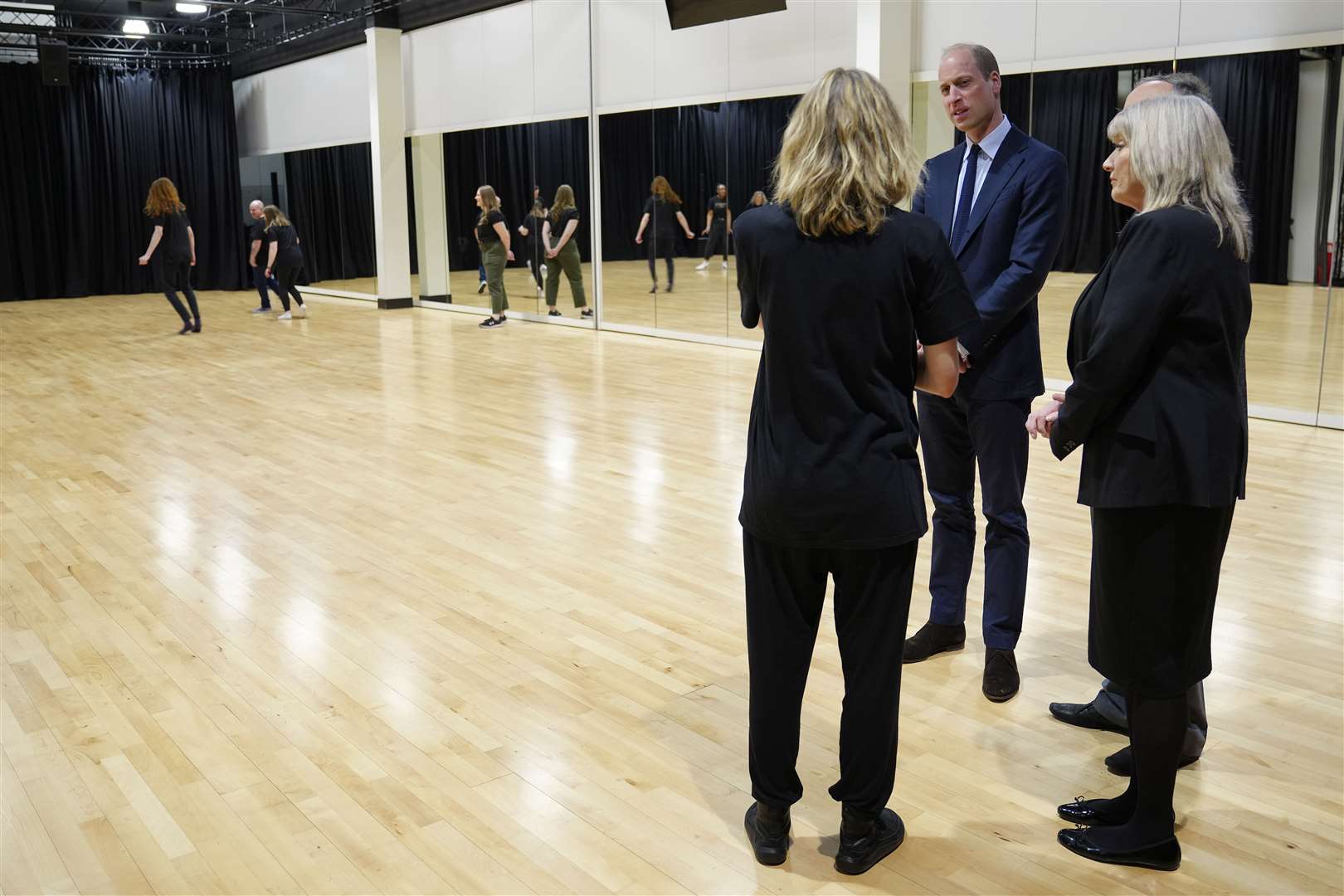 The Prince of Wales talking to staff at the charity’s onsite theatre as service users take part in an improvisation session (Jon Super/PA)