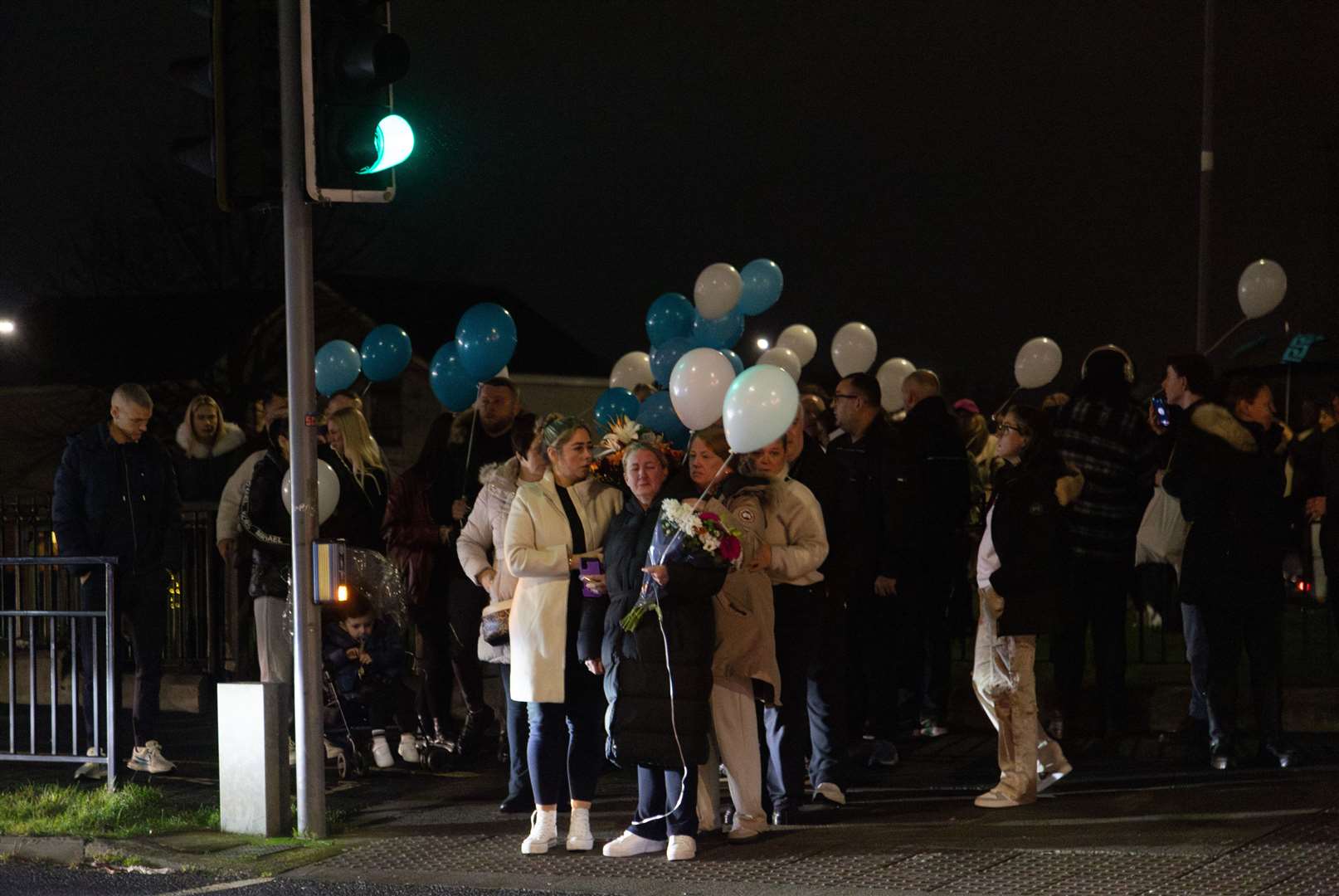 People attend a vigil at the scene in Blanchardstown Road North on Friday night (Evan Treacy/PA)