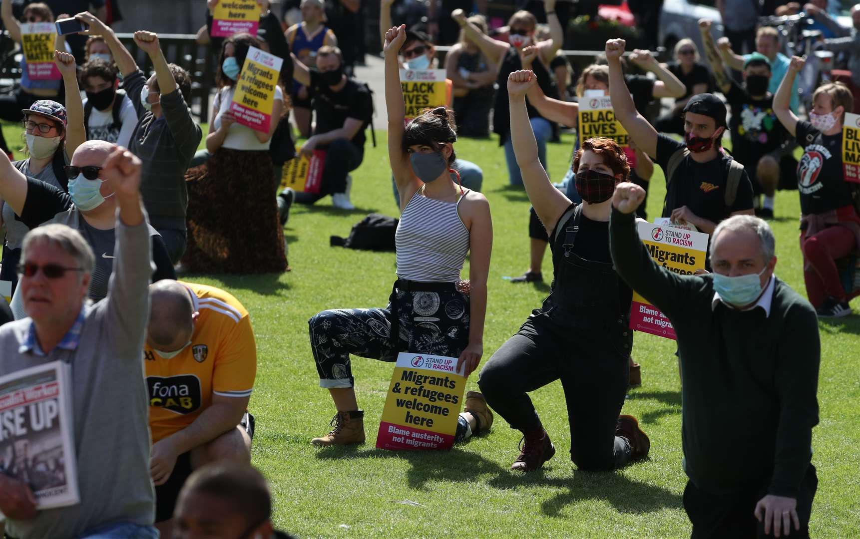 Protesters take a knee in George Square (Andrew Milligan/PA)