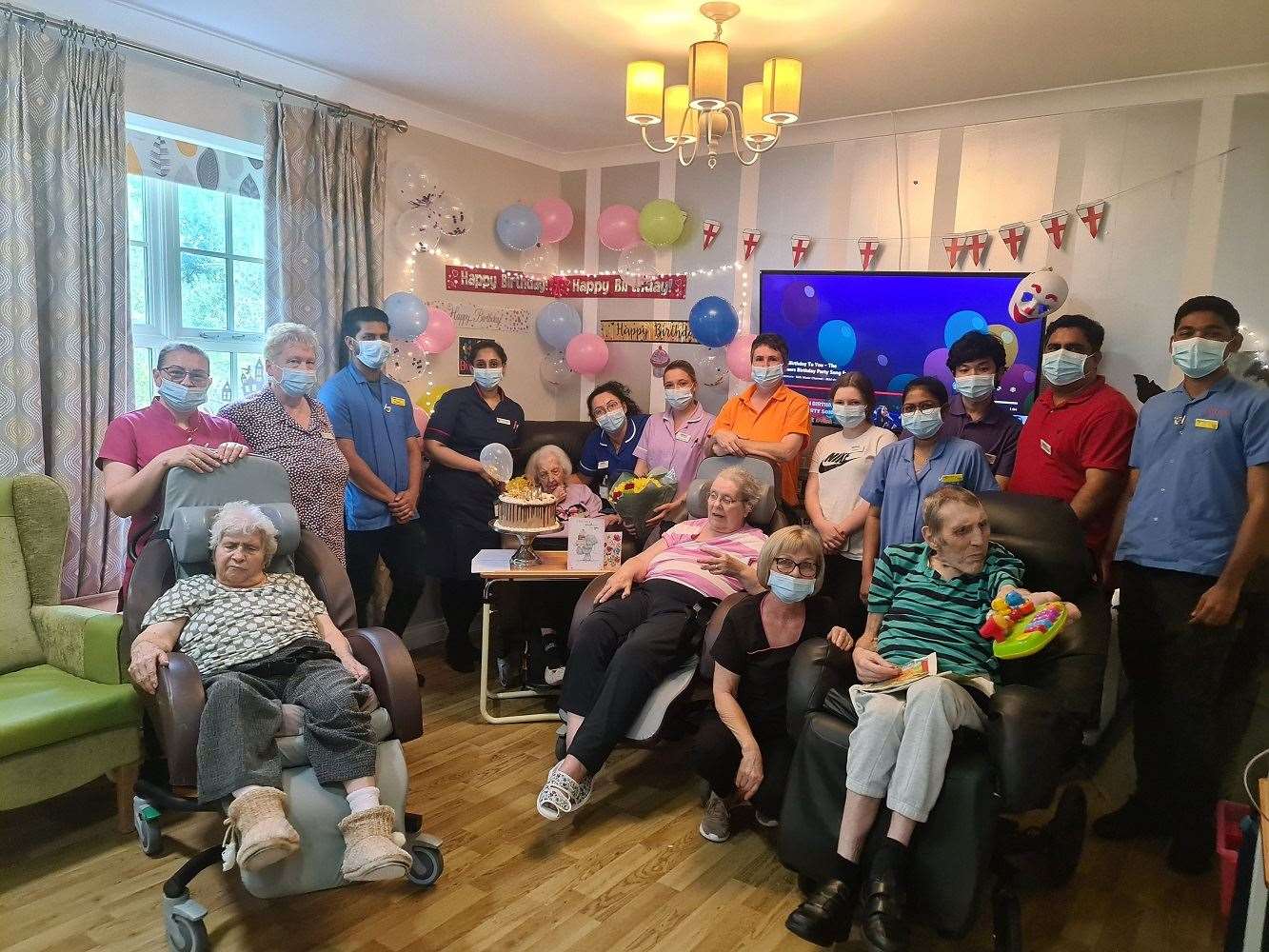 Joyce Tofts celebrates her 102nd birthday alongside her fellow carers and residents at Princess Christian Care Centre (Princess Christian Care Centre/PA)