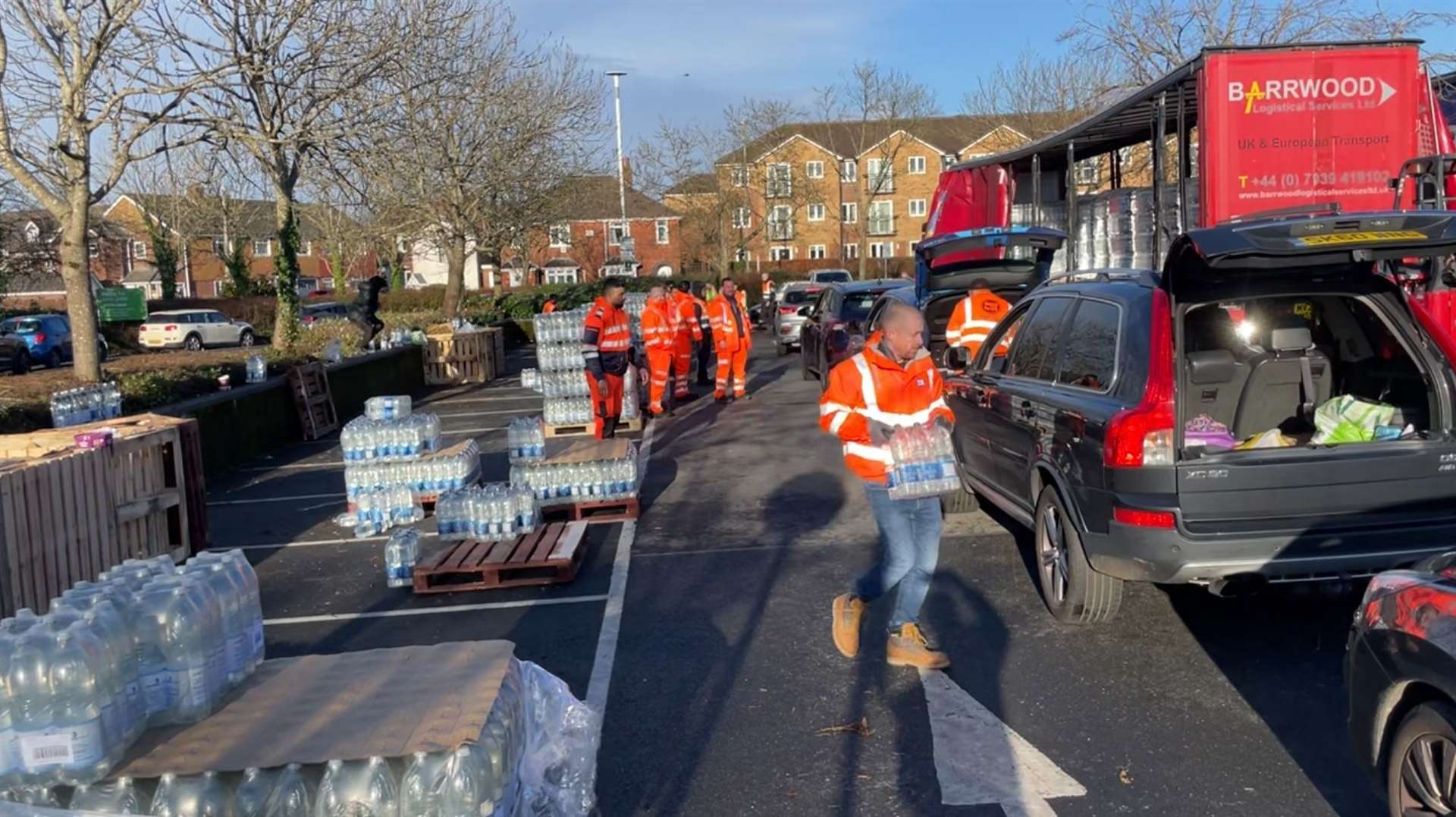 Customers line up for their water allocation (Ben Mitchell/PA)