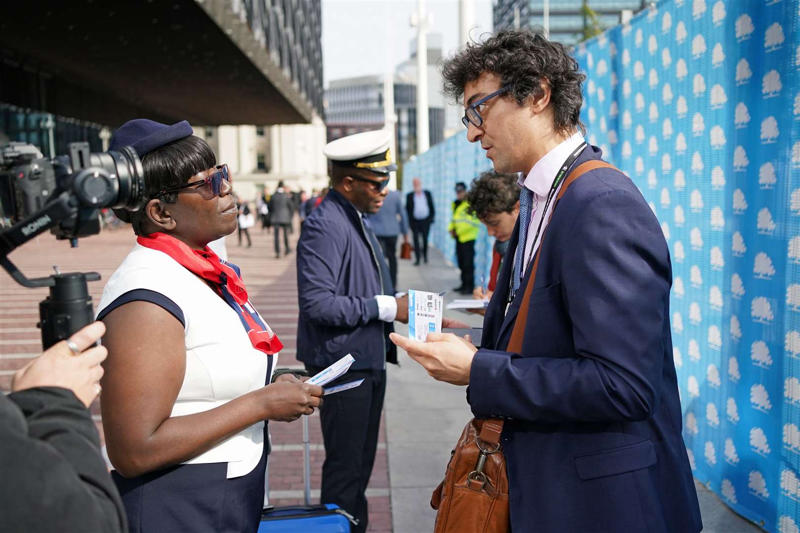 Refugees presented Tory delegates with ‘one-way tickets’ to Rwanda during a protest outside the Conservative Party annual conference (Jacob King/PA)