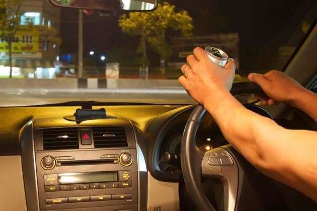Driver drinking at the wheel. Picture: iStock
