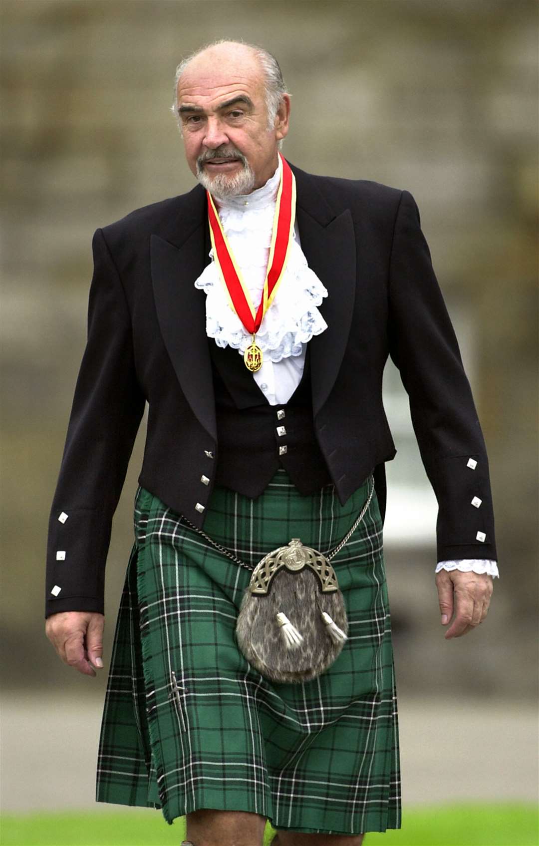 Sir Sean Connery, donning full Highland dress and wearing his medal after he was formally knighted by the Queen (David Cheskin/PA)