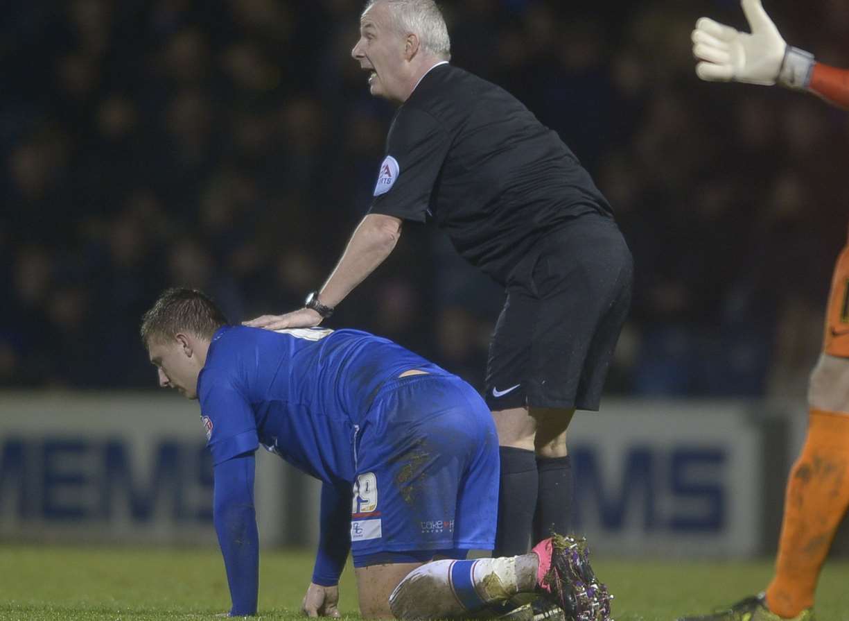 Luke Norris waits for treatment after picking up an ankle injury on Saturday Picture: Barry Goodwin