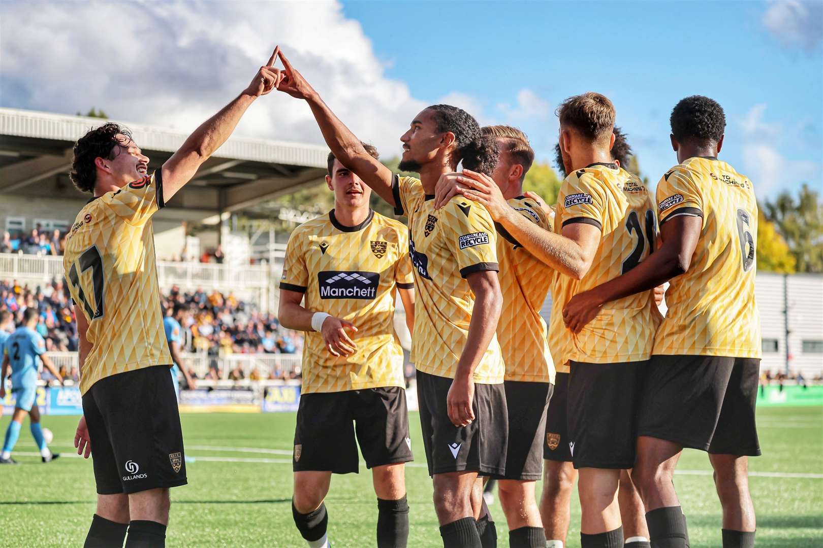 Aaron Blair, centre, celebrates with Maidstone team-mates after opening the scoring against Slough. Picture: Helen Cooper