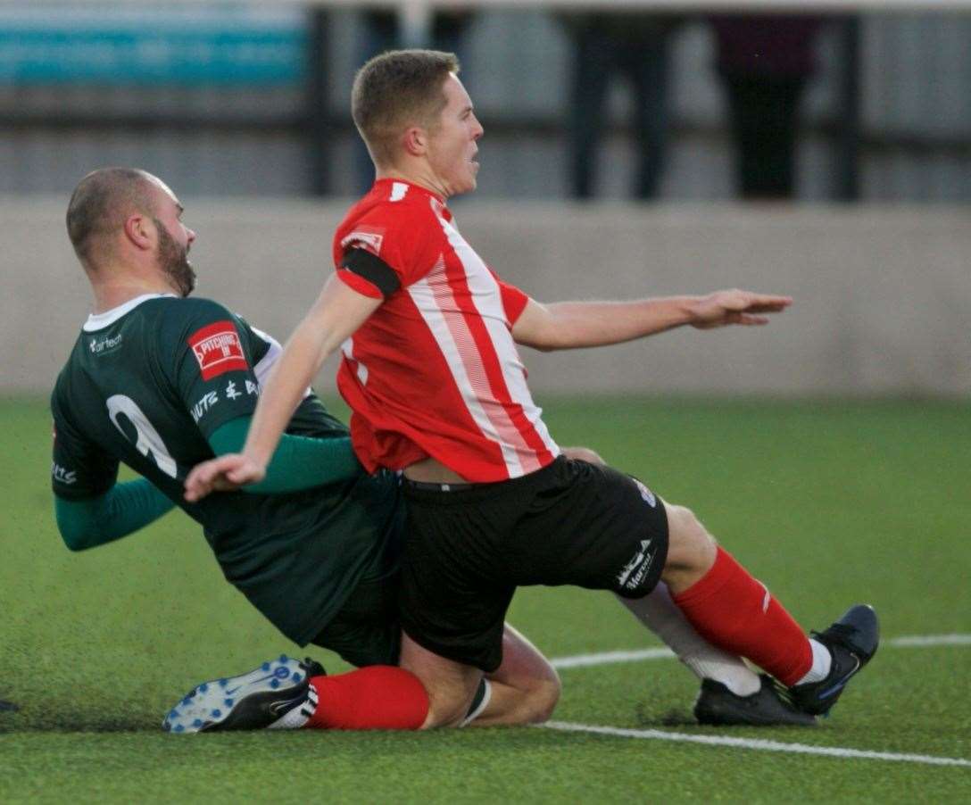 Ashford matchwinner Gary Lockyer gets to the ball before Sheppey's Joe Tyrie to score in the Nuts & Bolts’ 2-1 Isthmian South East victory at Holm Park. Picture: Ian Scammell