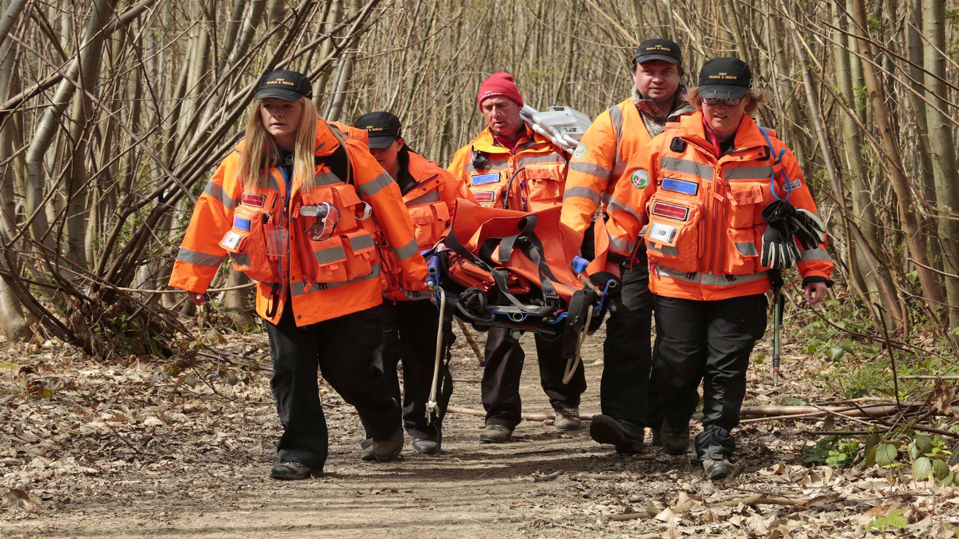 They use a stretcher to carry the youngster out of the woods. Picture by Martin Apps.