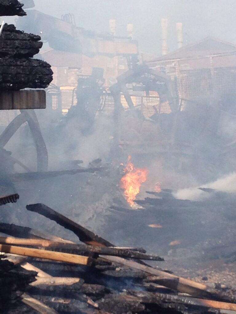 Flames in the wreckage of a blaze at a builders merchants. Picture: @Busa_Bloodbike