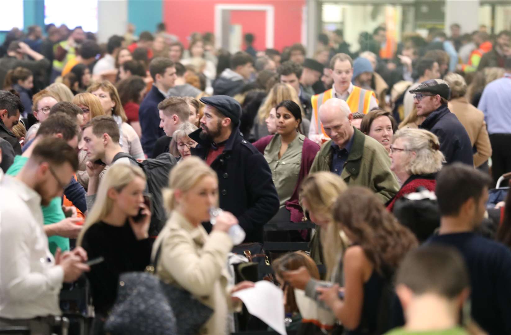 Passengers at Gatwick airport waiting for their flights following the delays and cancellations brought on by drone sightings (PA)