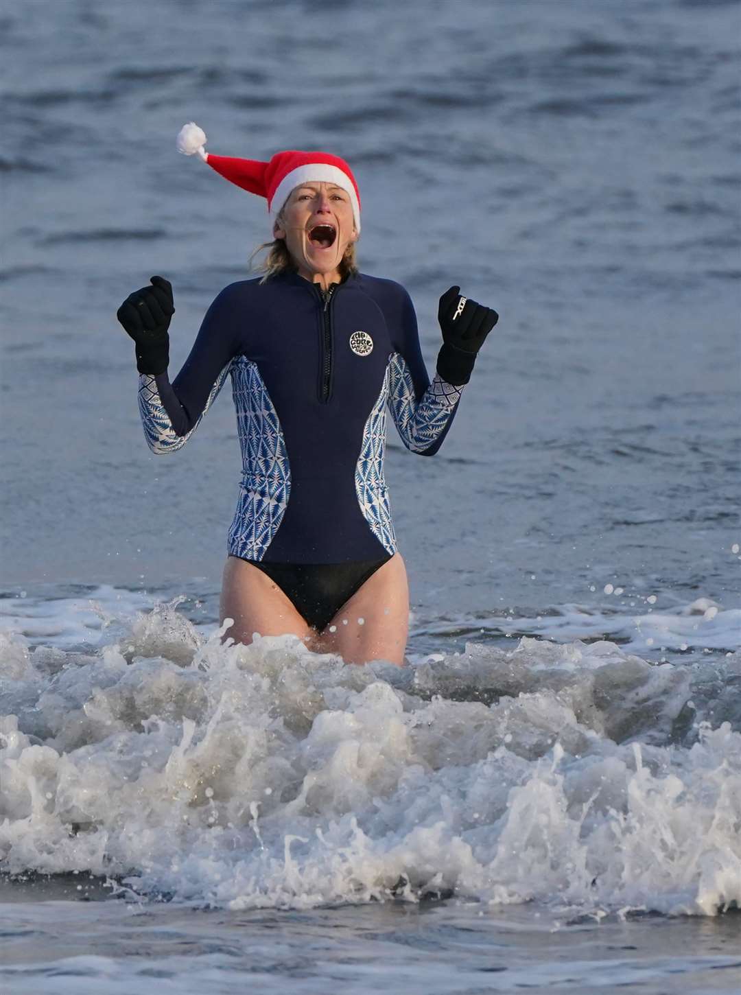 A swimmer takes a Christmas Day dip at Portobello Beach in Edinburgh (Andrew Milligan/PA)